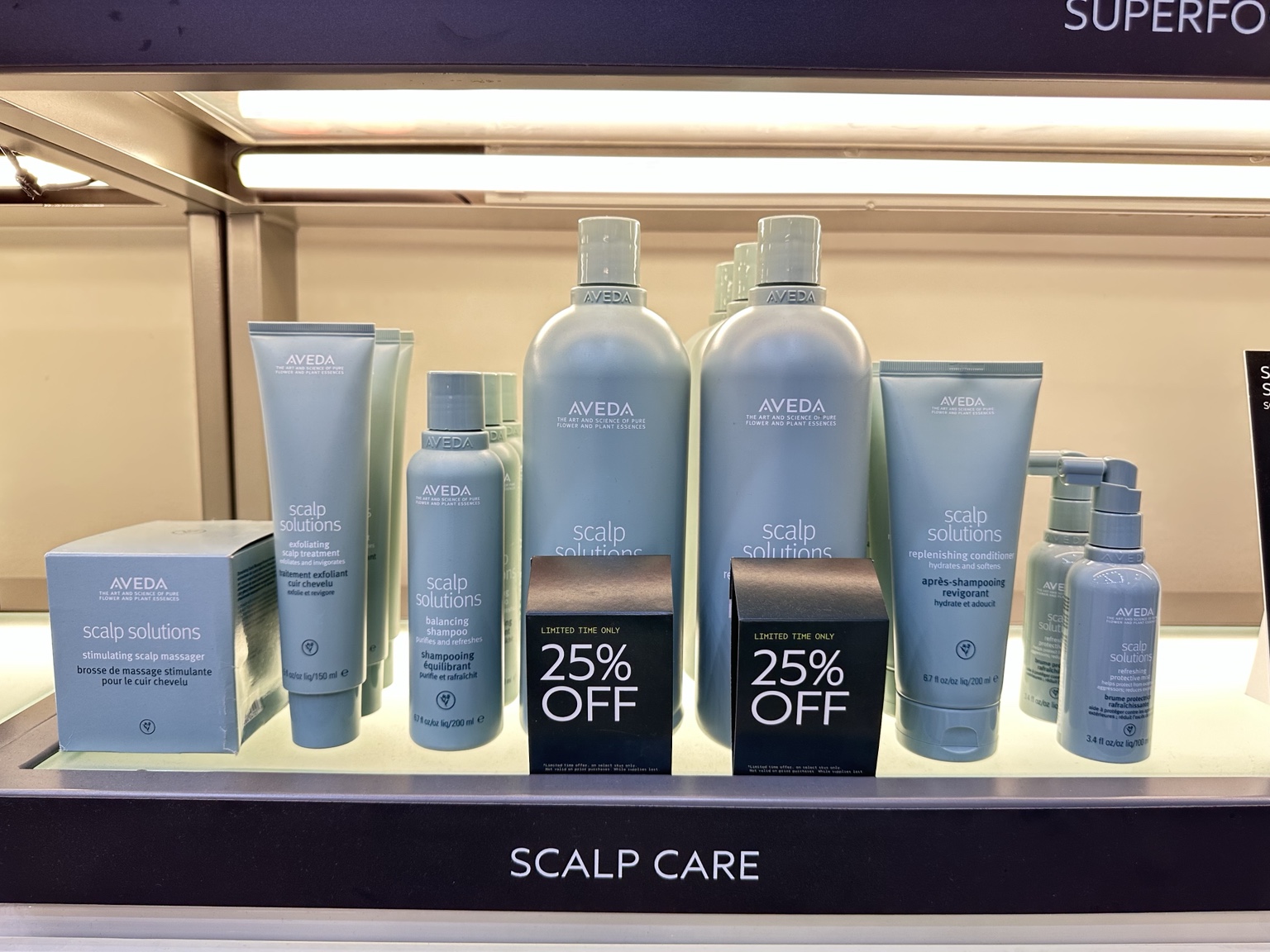 AVEDA Scalp Solutions display at ecoChic AVEDA Lifestyle Salon & SPA in Victoria BC with 25% off 1 litre balancing shampoo and replenishing conditioner